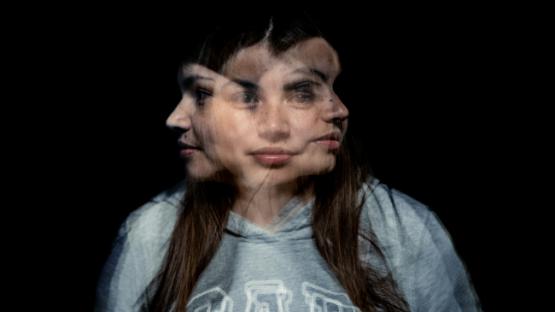 A blurred photo of a woman facing in three directions